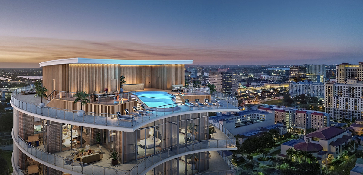Rooftop pool and lounge terrace glowing at dusk above a modern city skyline.